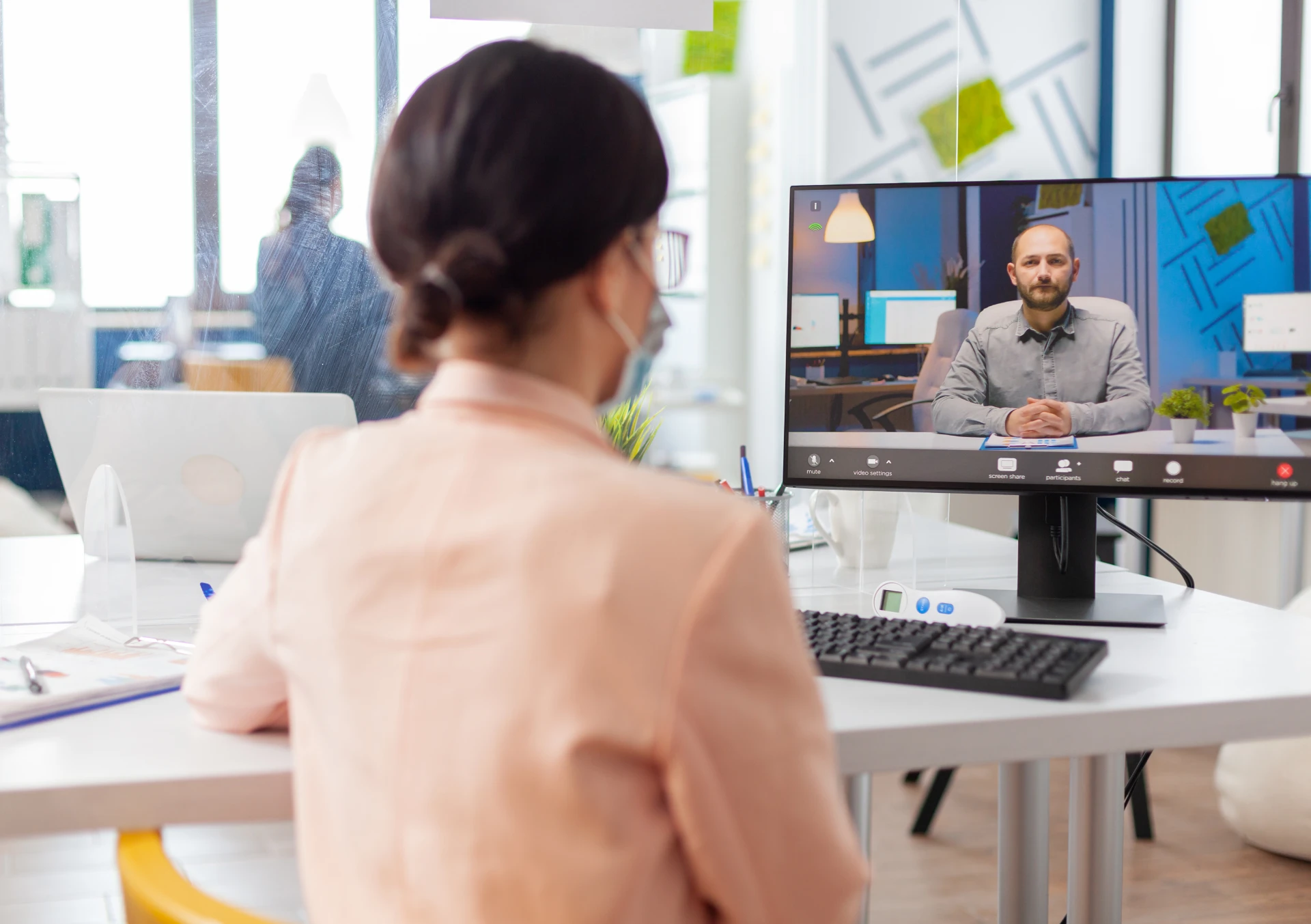 woman-new-normal-office-listening-man-talking-online-video-conference-looking-screen-discussing-project-coronavirus-flu-outbreak